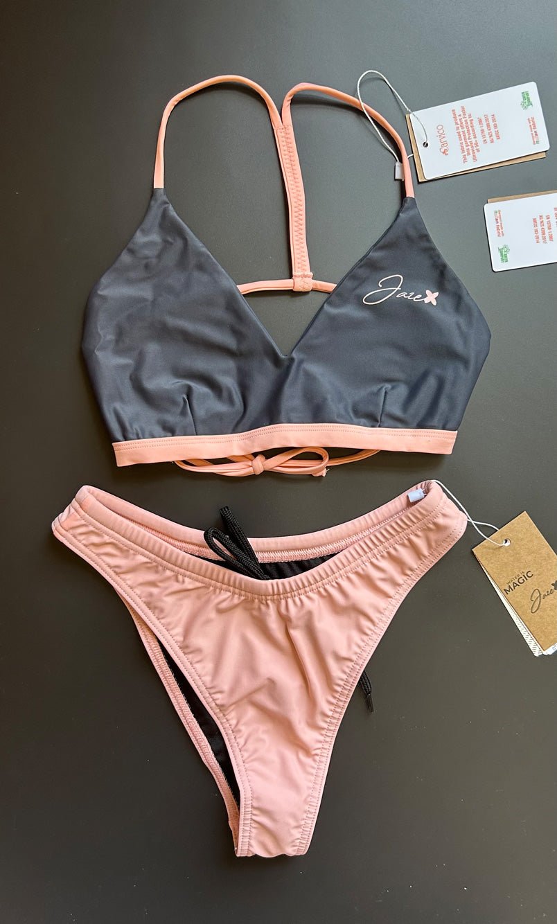 The Arya Bikini Top by Jaze shown from the front comes with thin, pink stripes and is combined with our sunrise bikini bottom.