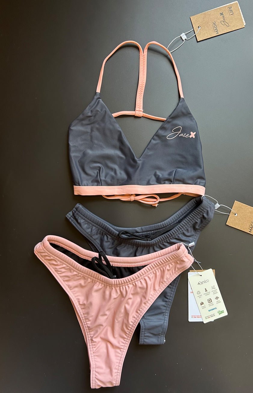 The Arya Bikini Top by Jaze shown from the front comes with thin, pink stripes and is combined with our midnight or sunrise bikini bottom. Mix & Match.