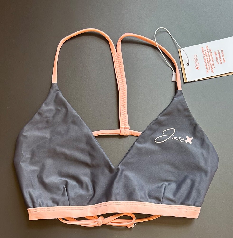 The Arya Bikini Top by Jaze shown from the front comes with pink, thin stripes.
