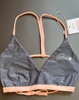The Arya Bikini Top by Jaze shown from the front comes with pink, thin stripes.