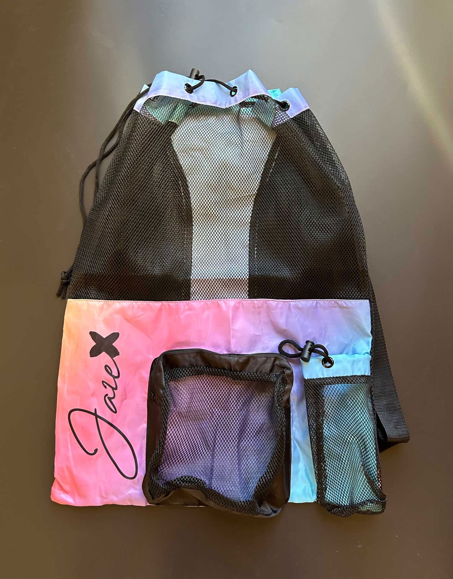 Equipment Mesh Baglying on a black surface shown from the front, showing the generous size and numerous pockets.