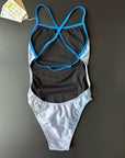 FLOWER OF LIFE - One-Piece Swimsuit lying on a black surface and shown from the back with its open back and thin blue adjustable straps.
