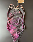 Flower of life One-Piece Swimsuit in black lying on a black surface shown from the front with focus on the hand drawn pattern.