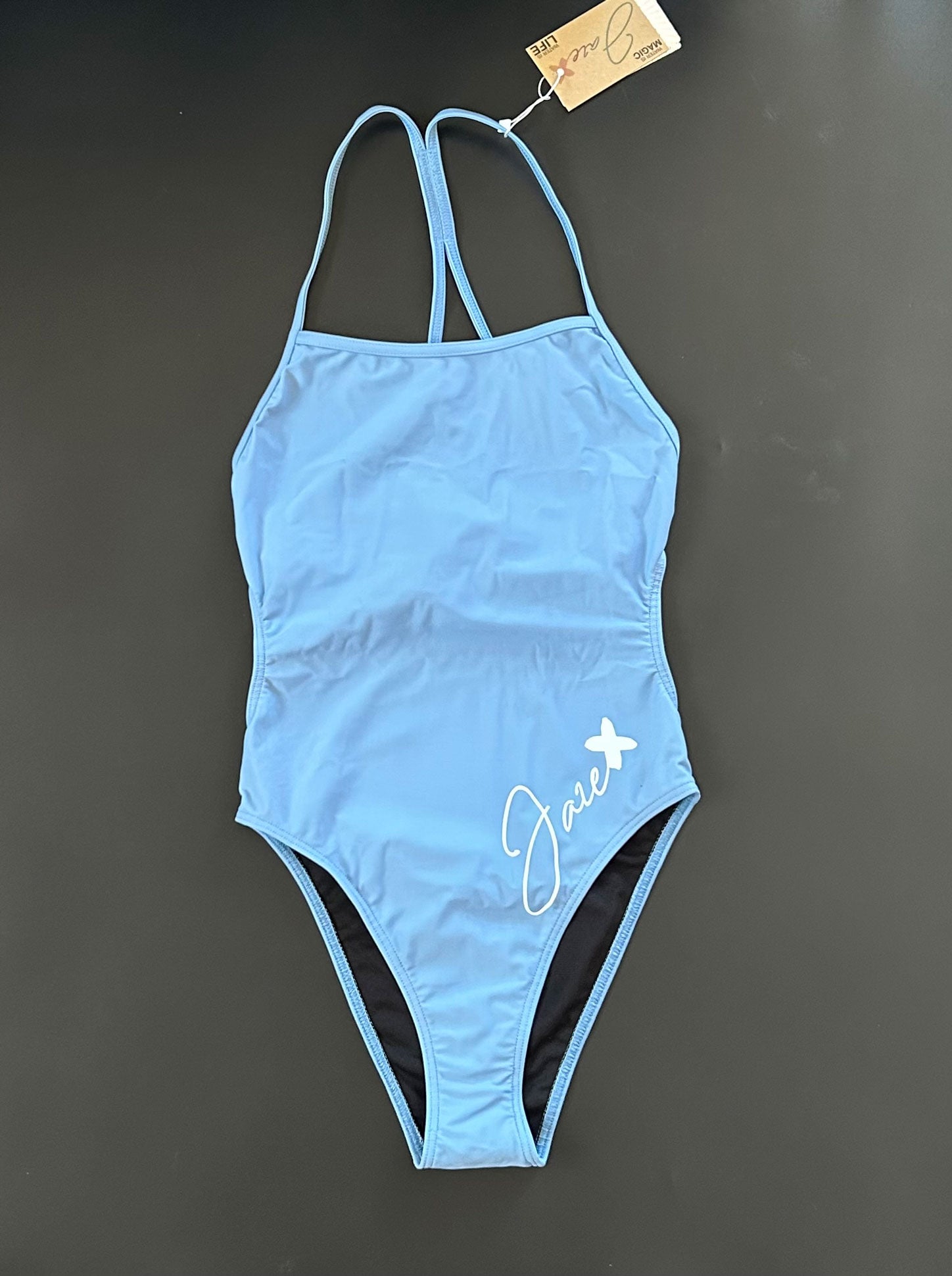 Our INTO-THE-BLUE One-Piece-Swimsuit shown from the front, lying on black background for more details.
