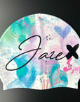 Our Swim Cap - Watercolor is a colorful Cap that has a white base with lot of symbols like hearts, moon, flowers and a beautiful splash of colours, all fluently united.