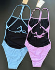 Our INTO-THE-BLUE and lavender One-Piece-Swimsuit shown from the back, lying on black background for more details. Same cut, different fresh colors.