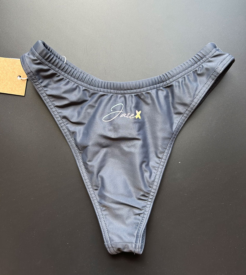 Our Midnight Bikini Bottom shown from the back, which comes in dark gray lying on a black background for more details.