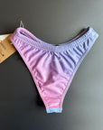 The RAINBOW - Bikini Bottom shown from the back clying on a black surface for more details.