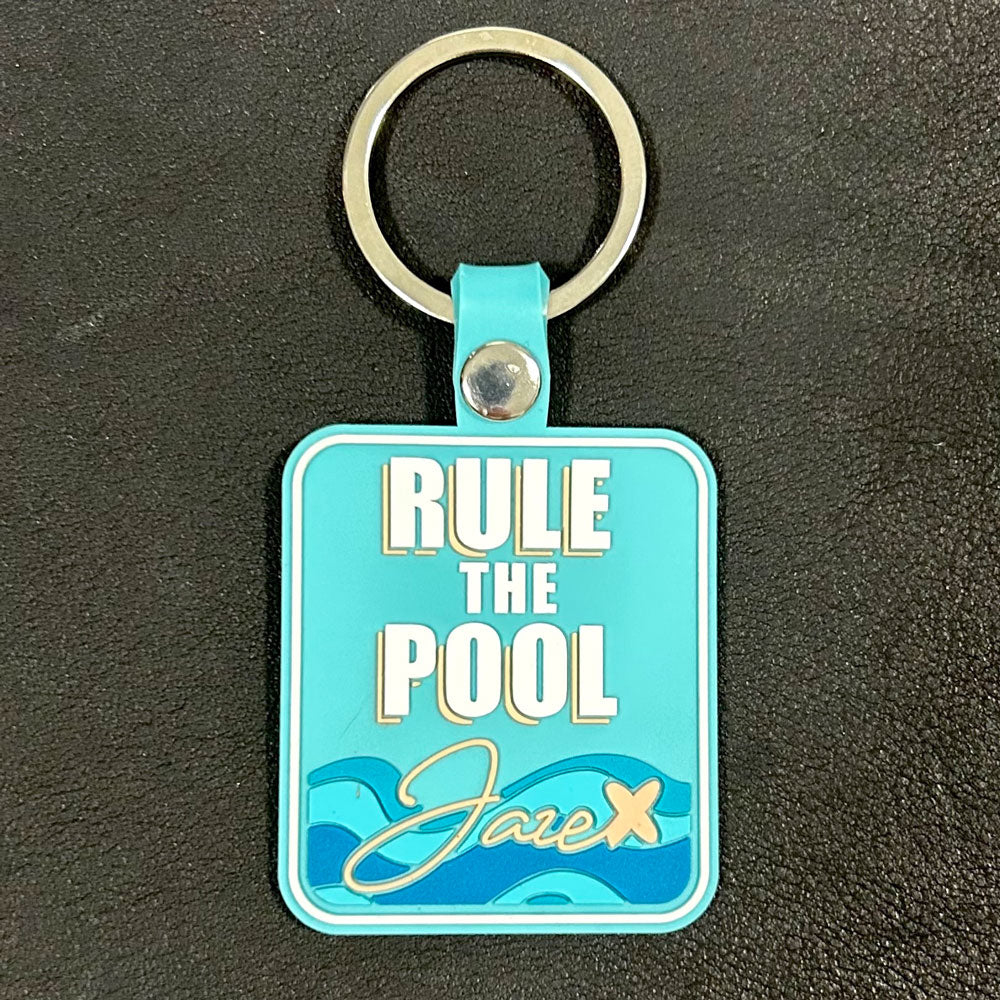 Key chain "Rule the Pool" in turquoise with blue waves and the jaze logo with metal key ring, perfect for swimmers.