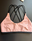 Sunshine Bikini Top displayed on a black background, highlighting its sleek design and bright color.