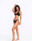 Three-quarter front view of black Alana bikini bottom highlighting side strap design