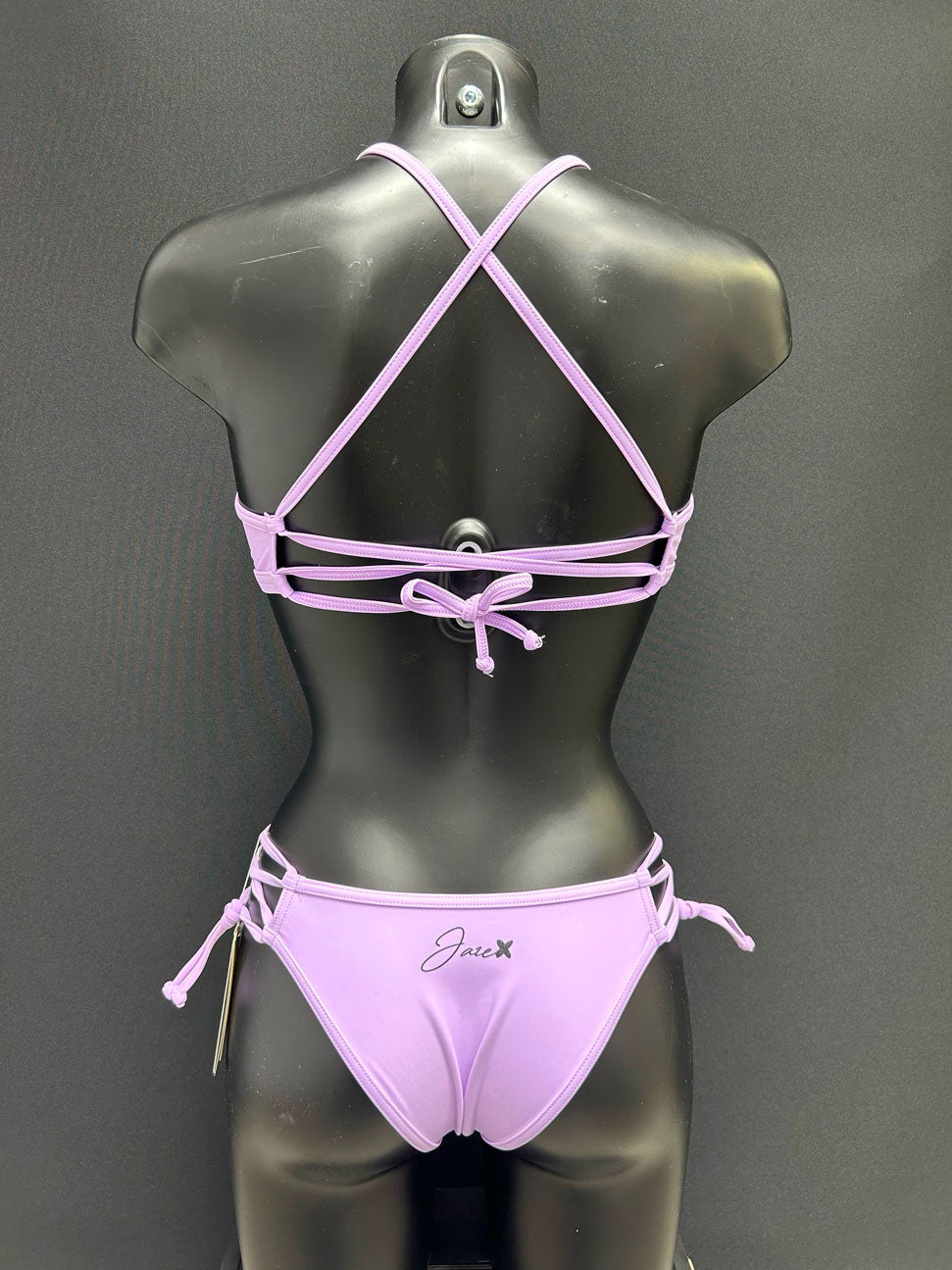 Back view of the Jaze Ariel lavender bikini bottom on a mannequin, showcasing cheeky cut and durable eco-friendly fabric.
