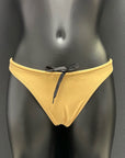 Front view of honey yellow bikini bottom by Jaze on mannequin, featuring cheeky cut, secure inner drawstring and soft eco-friendly Italian fabric.