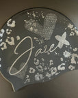 Swim Cap - Onyx with stylish silver glitter print lying on a black surface for more details.