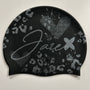 Swim Cap - Onyx with stylish silver glitter print lying on a black surface.