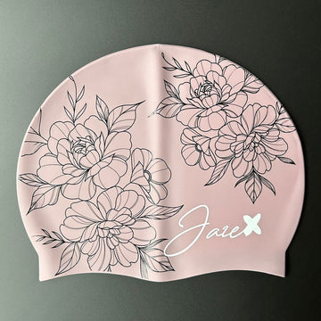 The ROSE – swim cap has a rose base and beautiful flowers, painted with fine, black lines.