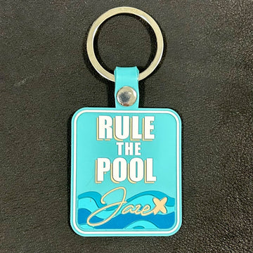 Key chain "Rule the Pool" in turquoise with blue waves and the jaze logo.