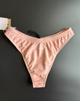 The peach Sunrise – Bikini bottom shown from the front comes with a high leg cut.