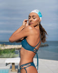 Our model wearing the Ariel Bikini shown from the side, while our model is putting n a swimming cap