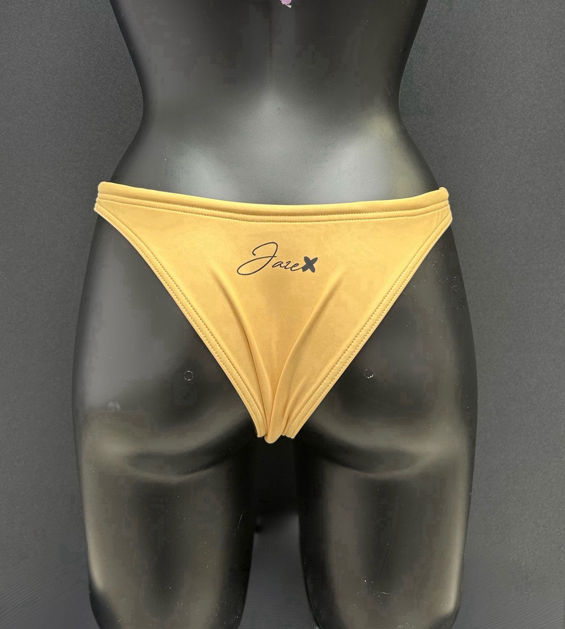 Back view of honey yellow bikini bottom by Jaze on mannequin, showing cheeky bum coverage, swimmer-approved design and long-lasting shape.