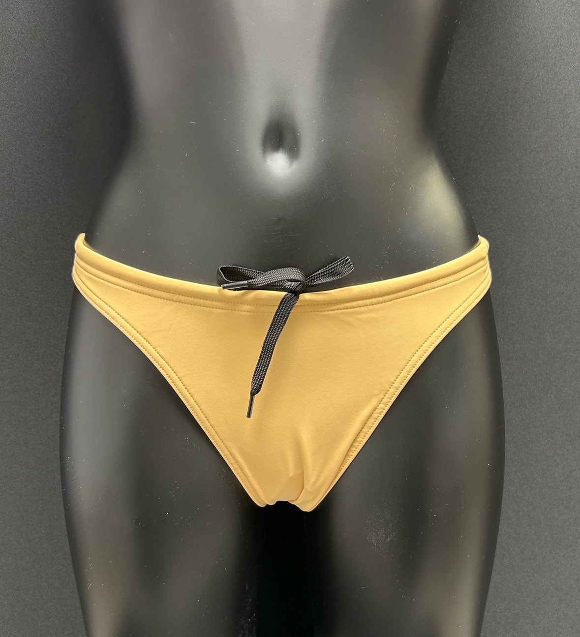 Front view of honey yellow bikini bottom by Jaze on mannequin, featuring cheeky cut, secure inner drawstring and soft eco-friendly Italian fabric.