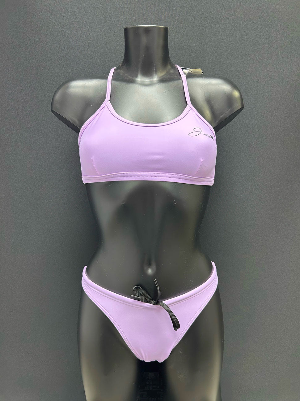 Front view of cheeky-cut bikini bottom in color lavender by jaze on mannequin, designed for performance with small bum coverage and adjustable inner drawstring.