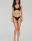 Model wearing black Lilly bikini top in full body front view with matching bikini set