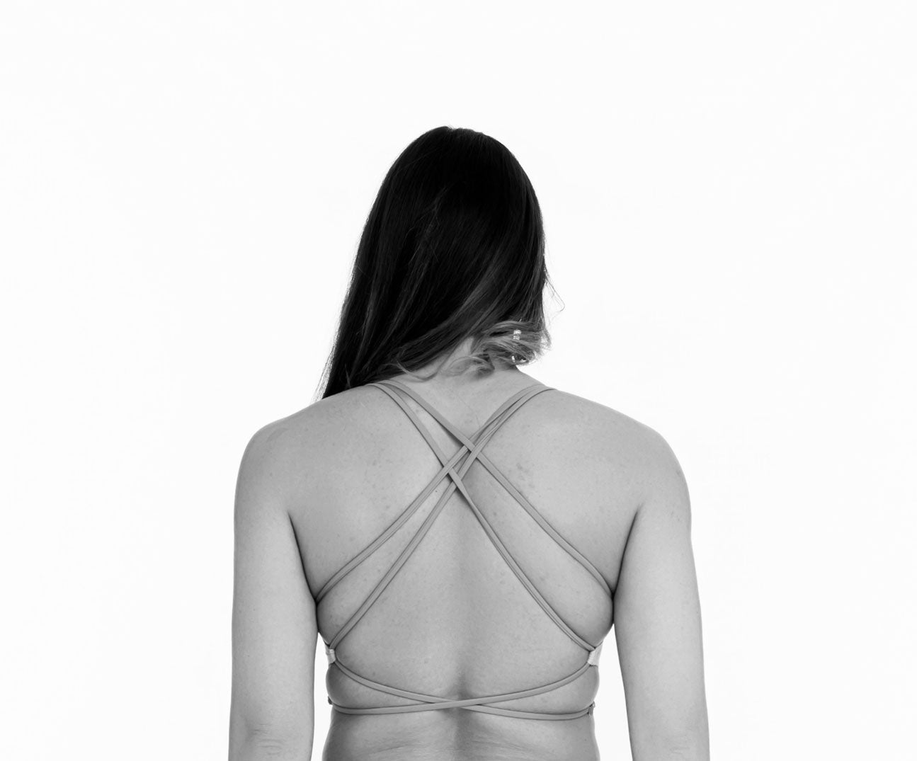 Back view of lila one piece swimsuit with cross back straps and open back design