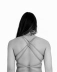 Back view of lila one piece swimsuit with cross back straps and open back design